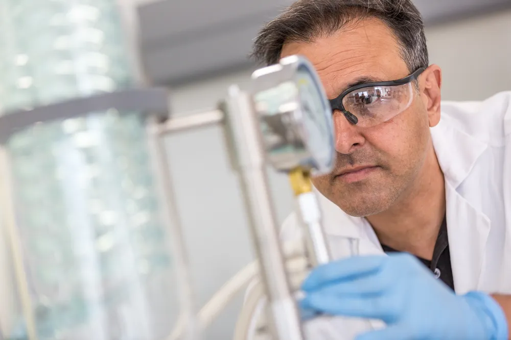 Scientist inspecting a sample in a SiSaf laboratory